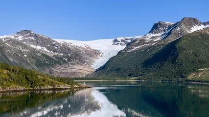 Rucksack A panoramic display of the Svartisen Glacier descending into lush greenery, with its beauty mirrored in the glassy fjord, encapsulates the serenity of the Arctic © Artem