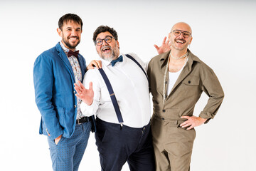 Three Smiling Queer Men Posing Together in Stylish Outfits Against White Background