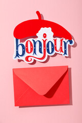 The word "bonjour" with a beret on a pink background. © Atlas