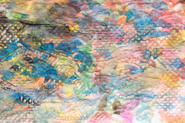 Watercolor different colors splashes and shapeson textured rough paper macro