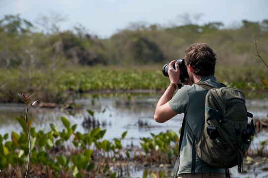 adventurer photographing wildlife in a remote swamp