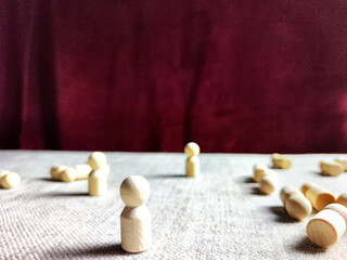 Fototapeta premium A lot of lying wooden toys and one standing one. There is an opportunity to win even when others give up. The strongest ones win. The loneliness of a leader in business