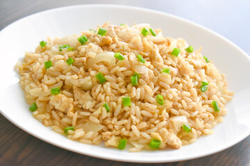 Egg fried rice on a white plate. Flat lay top view photo.