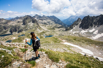 Young hiker girl summit to Ratera Peak in Aiguestortes and Sant Maurici National Park, Spain