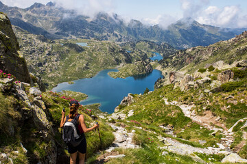 Young hiker girl summit to Ratera Peak in Aiguestortes and Sant Maurici National Park, Spain