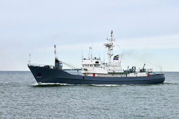 Russian warship armed with armament sails into sea toward military target to attack and destroy enemy, military ship performing strategic maneuver, Russian sea power deployment for tactical advantage