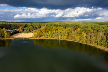Aerial shot of beautiful lake surrounded by forest in a calm autumn day. Germany. - 741366491