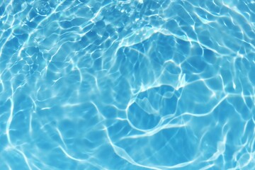 Blue water surface texture with ripples, splashes, and bubbles. Abstract summer banner background Water waves in sunlight with copy space cosmetic moisturizer micellar toner emulsion. Blue water wave.