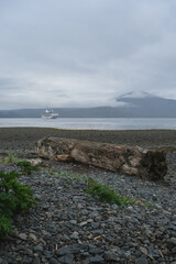 Luxury cruiseship cruise ship liner Regatta anchored in Sitka Bay, Alaska on foggy low hanging cloud day with beautiful lush nature landscape coast scenery travel adventure