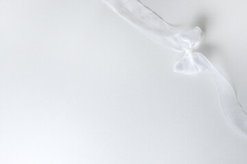 White tulle fabric ribbon with bow on white background