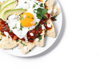 Traditional Mexican breakfast red chilaquiles with egg isolated on white background. Top view. Copy space