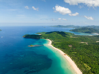Nacpan Beach with sea waves crashing on cream colored sands. El Nido, Philippines.