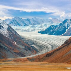 Panoramic view of a glacier on a high-altitude plateau. Panorama of the glacial mountain valley in autumn