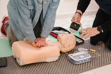 Indirect heart massage. Automated external defibrillator device, AED with training dummy mannequin....