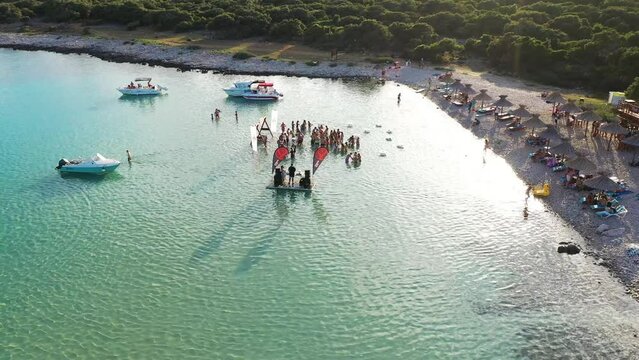 Aerial view of beach party and people at Meli Beach, Island Cres, Croatia.
