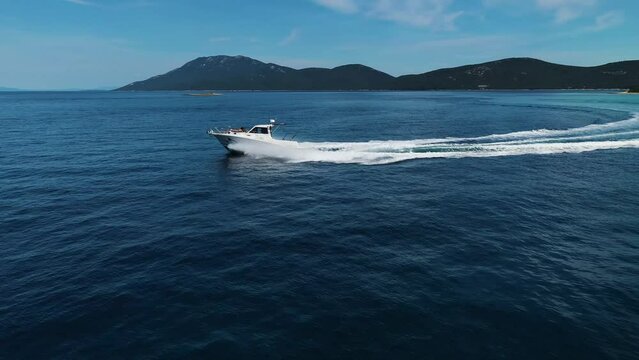 Aerial view of speedboat on the blue ocean with scenic shoreline, Zara, Croatia.