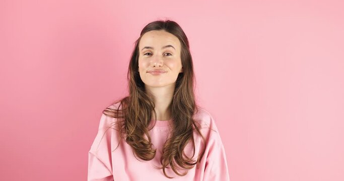 Be quiet, i won't tell anyone, keep secret forever, confidential information. Attractive playful woman uses sign language zips mouth with hands asks to keep secret has mysterious on pink background.