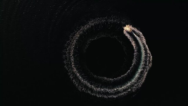 Aerial view of speedboat on refreshing blue sea with spirals and whirl, Zara, Croatia.