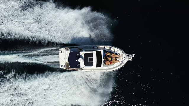 Aerial view of a speedboat and sailboat sailing on the blue waters of Zara, Croatia.