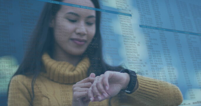 Image of data processing over biracial woman using smartwatch - Powered by Adobe