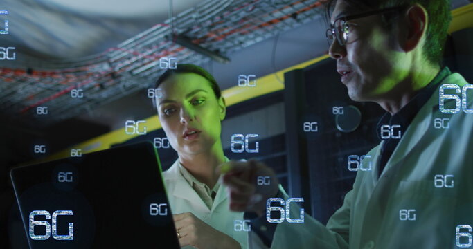 Image of falling 6g text over diverse couple of server room workers - Powered by Adobe