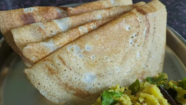 Panoramic shot of homemade masala dosa with mashed potatoes served on a plate on the table