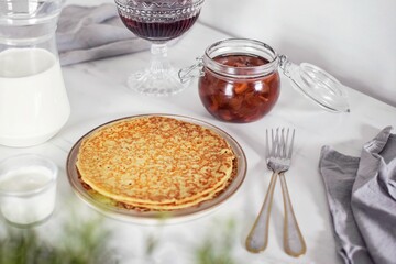 Pancakes with various jams and sour cream. Breakfast on the table