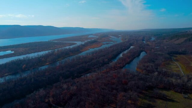 Autumn Overlook Aerial Views of Volga River, Forest, and the Grushinsky Festival Meadow in Warm Glow. Nature of Russia view from a drone in autumn