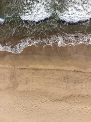 Summer seascape, beautiful waves, blue sea water on sunny day. Top view from drone. View of sea from height of tropical nature. Beautiful bright sea with lapping waves and beach sand concept