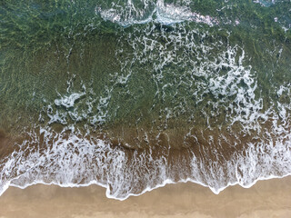 Summer seascape, beautiful waves, blue sea water on sunny day. Top view from drone. View of sea...