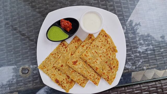 Indian famous food aloo paratha / potato stuffed flat bread served with yogurt,chutney