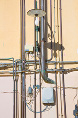 Electrical and telephone cables against a surrounding - water and gas pipes varnished fixed with...