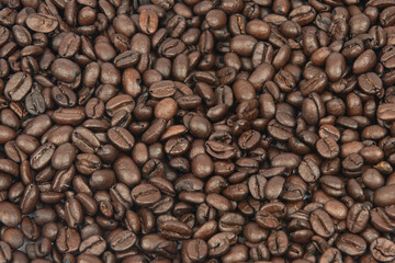 Coffee bean background. Roasted coffee beans on the entire surface. Brown coffee. Flat layout with top view.