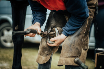 Horseshoe craftman working and adjusting horseshoe