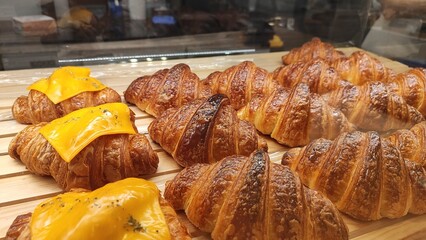 Fresh croissants on display in the bakery window