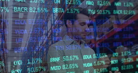 Image of stock market over caucasian worker in warehouse