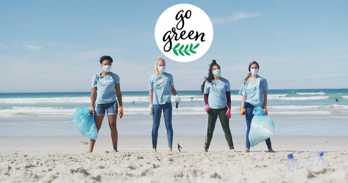 Image of go green text and logo over happy diverse group wearing face masks cleaning up beach