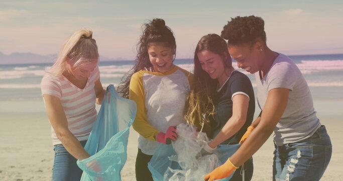 Diverse group of women participate in a beach cleanup