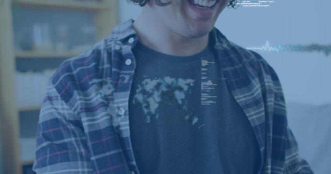 Image of data processing over disabled cuacasian man sitting in wheelchair using smartphone