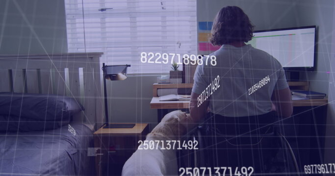 Image of data processing over disabled cuacasian man sitting in wheelchair using computer - Powered by Adobe