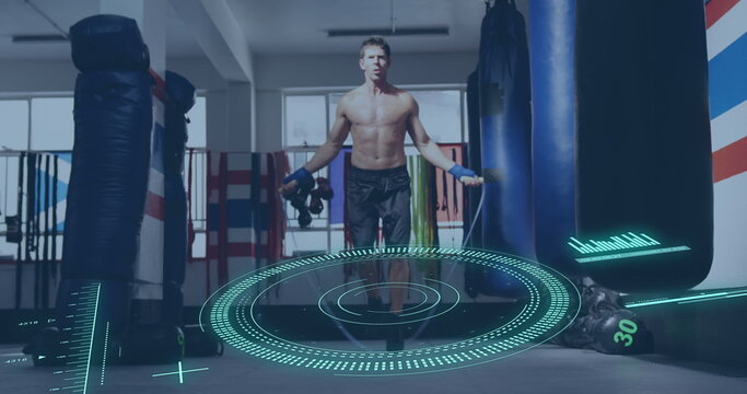 Image of scope scanning and data processing over caucasian man jumping rope at gym - Powered by Adobe