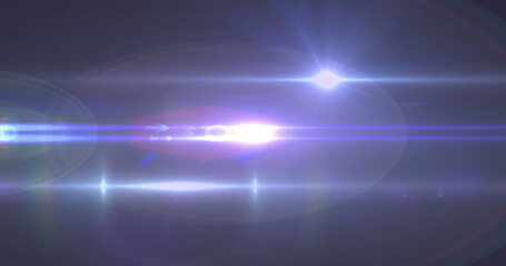 Image of light beams moving over dark background