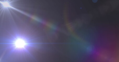 Image of spotlight with lens flare over dark background