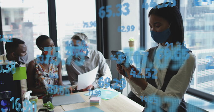 Image of financial data processing over diverse business people in face masks in office