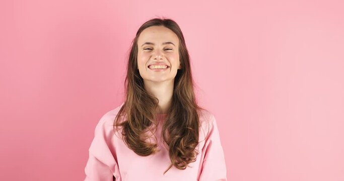 Amazed excited woman win in lottery in pink long sleeves top open mouth in surprise looking at camera with big eyes, shocked isolated on pink background. Oh my god wow, yes gesture, win symbol.