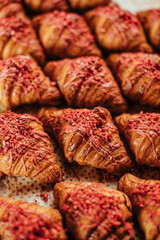 Freshly baked croissants aligned on plate