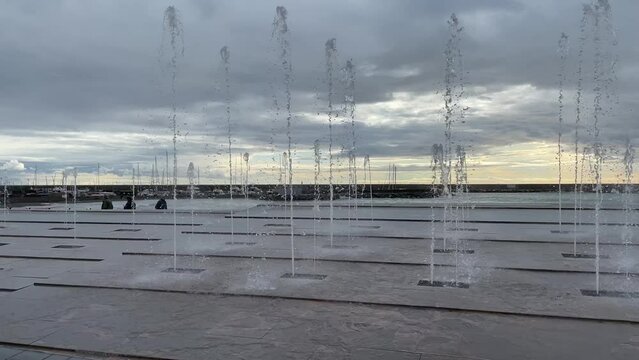 Small square of fountains spraying water towards the sky