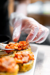 professional chef's hands making sushi roll in a restaurant kitchen