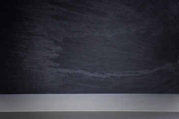 Background of wooden table and black textured stone.