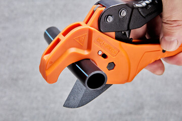 Ratchet action PVC pipe cutter for one-handed use.